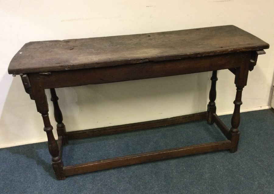 An antique oak side table. Est. £40 - £60.