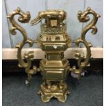 A heavy tall brass two handled centrepiece with el