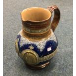 A Royal Doulton Lambeth stoneware jug. Approx. 19
