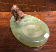 An agate ashtray mounted with a cold bronze figure