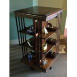 A mahogany revolving bookcase. Est. £50 - £80.