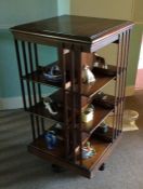 A mahogany revolving bookcase. Est. £50 - £80.