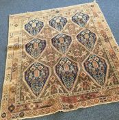 An old patterned rug. Est. £20 - £30.