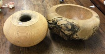 A carved oak bowl together with a turned wooden bo