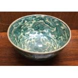 A Chinese green bowl decorated with flowers. Est.