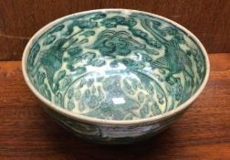 A Chinese green bowl decorated with flowers. Est.