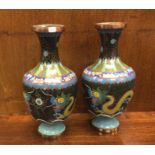 A pair of enamelled vases decorated with dragons.