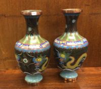 A pair of enamelled vases decorated with dragons.