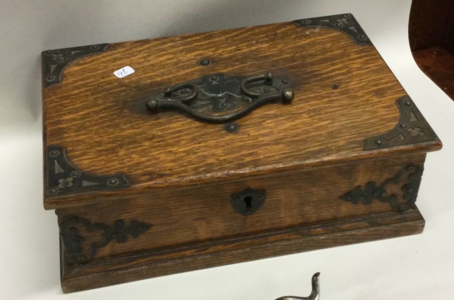 An Edwardian oak hinged top box together with cont