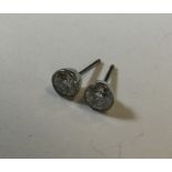 A good pair of diamond single stone ear studs in w