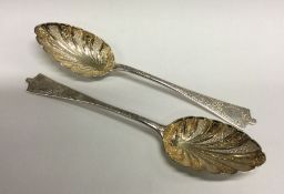 A pair of chased silver plated serving spoons. Est. £20 - £30.