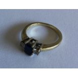 A sapphire and diamond three stone ring in gold cl