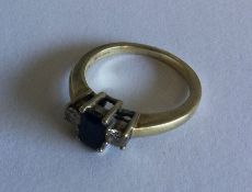 A sapphire and diamond three stone ring in gold cl