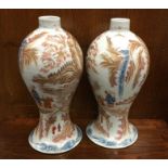 A good pair of Chinese shaped vases decorated in b