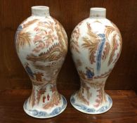 A good pair of Chinese shaped vases decorated in b