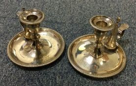 A heavy pair of crested George III silver chamber sticks with gadroon rims. London 1813. By