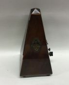 An old metronome. Est. £10 - £20.