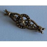 A 9 carat knot brooch with ball decoration. Approx