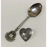 A silver brooch with blue stone together with an enamelled rifle spoon. Approx. 22 grams. Est. £30 -
