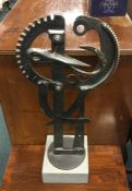 A stylish cast iron statue on wooden base. Est. £2