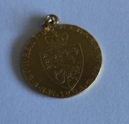 A George III gold Guinea with loop top. Approx. 9