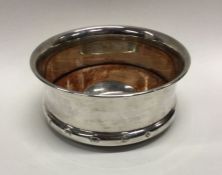 A heavy Millenium silver coaster. London 2000. By Carrs. Approx. 132 grams. Est. £80 - £120.