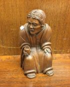 A good carved oak figure of a seated gentleman by