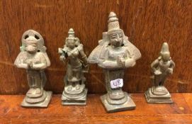 A group of brass figures on square bases. Est. £40