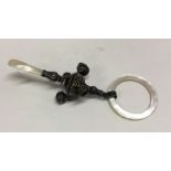 A silver and MOP rattle. Approx. 28 grams. Est. £50 - £80.