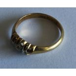 A small diamond three stone ring in gold mount. Ap