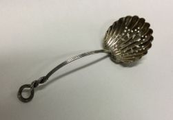 A heavy silver pierced sifter spoon with spiralled handle. Approx. 19 grams. Est. £20 - £30.