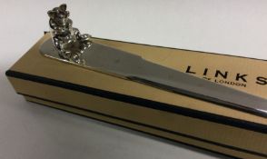 LINKS OF LONDON: A heavy cased letter opener mounted with a cast pig. 1995 Approx. 65 grams. Est. £