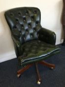 A leather button back office chair. Est. £40 - £60