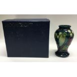 MOORCROFT: A boxed miniature green finches vase. E