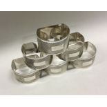 A decorative set of six engine turned silver napkin rings. Birmingham 1973. By Joshua Horton and