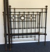 An old cast iron bed. Est. £50 - £80.