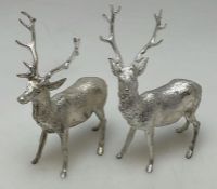 A heavy pair of cast silver figures of stags with