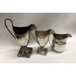 Three silver cream jugs. Various dates and makers. Approx. 287 grams. Est. £180 - £220.