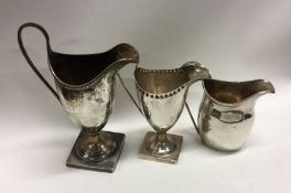 Three silver cream jugs. Various dates and makers. Approx. 287 grams. Est. £180 - £220.