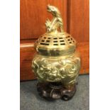 A tall Chinese brass pot pourri engraved with flow