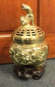 A tall Chinese brass pot pourri engraved with flow