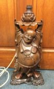 A Chinese hard wood figure of Buddha in the form o