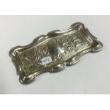 A stylish silver pin dish decorated with scrolls a