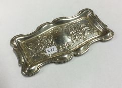 A stylish silver pin dish decorated with scrolls a