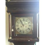 An oak cased Grandfather clock with silvered dial.