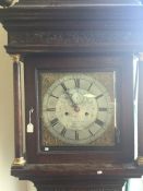 An oak cased Grandfather clock with silvered dial.