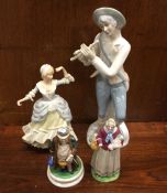 A group of four pottery figures. Est. £15 - £20.