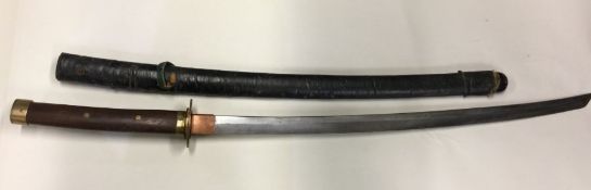 A large steel bladed Samurai sword with leather sh