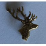 A small gold brooch in the form of a stag. Approx.