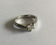 An 18 carat white gold single stone ring in claw m